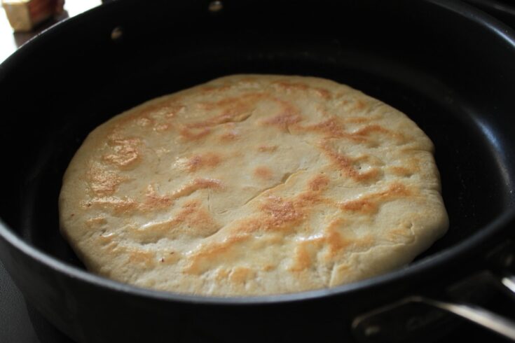 A toasty golden Georgina Kachapuri flatbread in a frying pan.