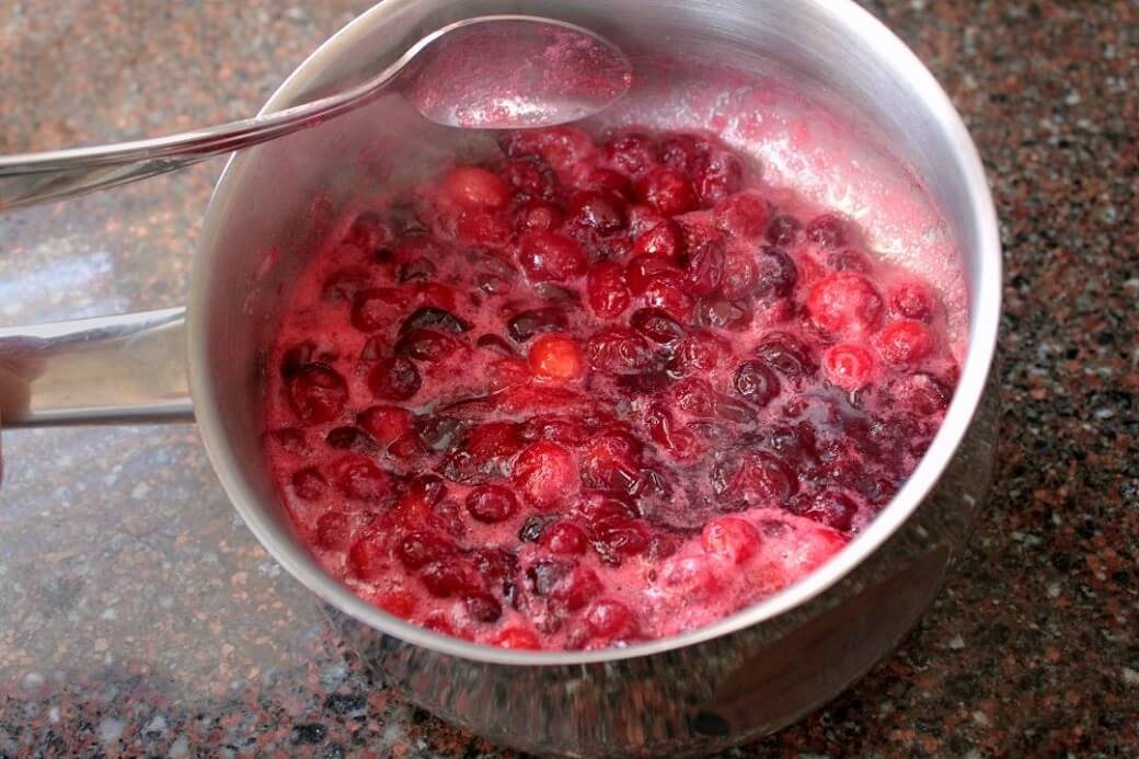 Cranberry Bars - A saucepan of boiling cranberries.