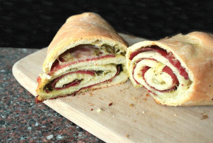 Italian Baked Stromboli Sandwich on a cutting board.