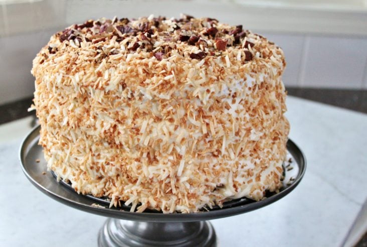 A decadent cream cake with pecans and coconut