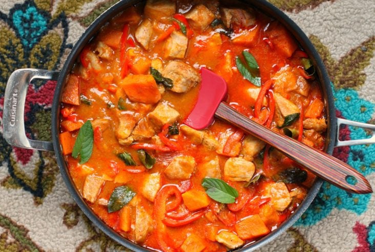A large pan full of vibrant Pork and Mango Curry.