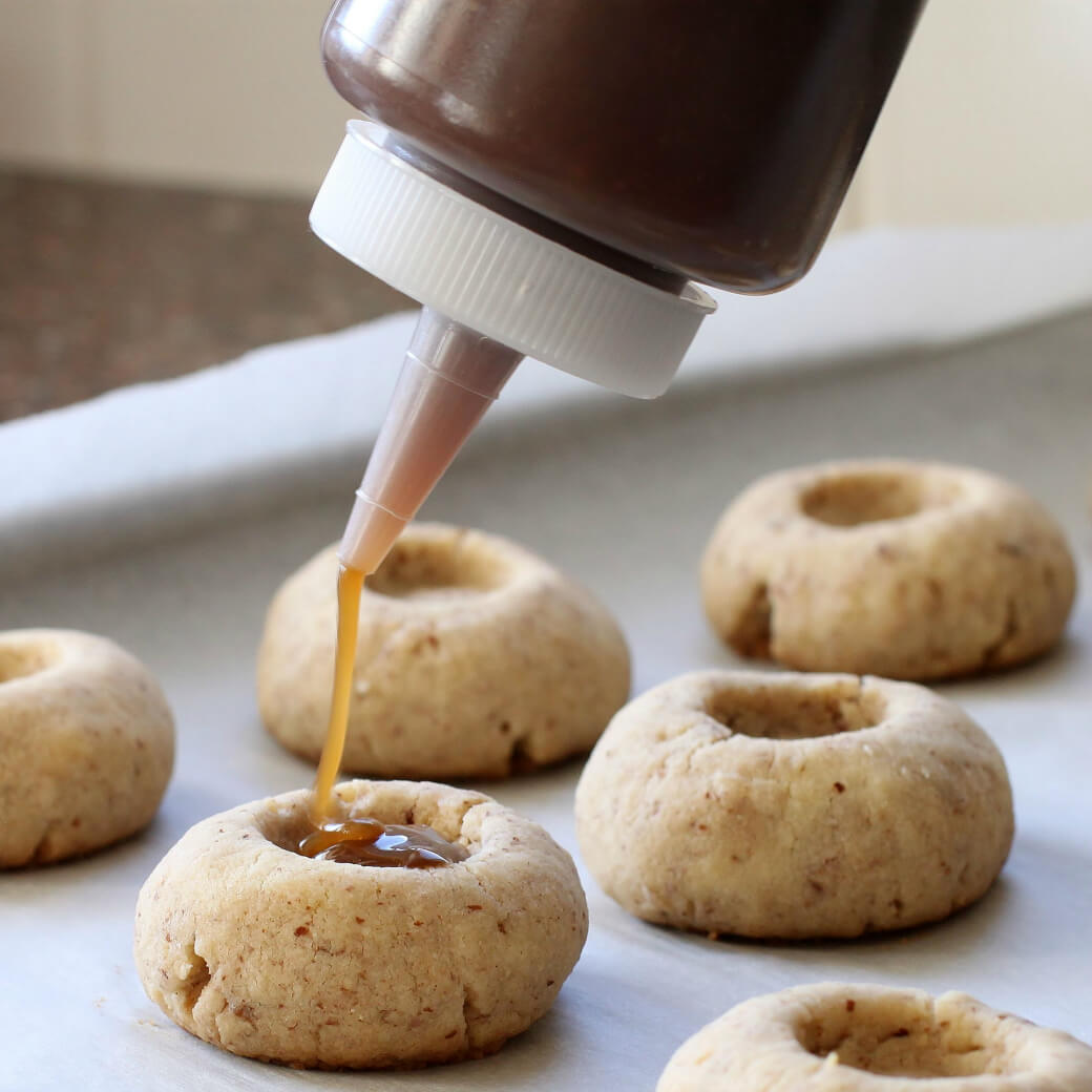 Pecan Polovorones - Freshly baked cookies being filled with caramel.