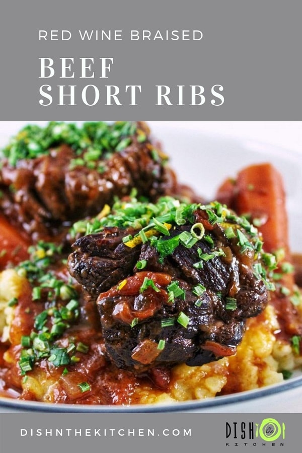 Pinterest image featuring braised beef short ribs in a rich beefy gravy with carrots over top of mashed potatoes.