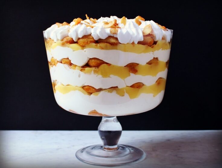 A bright layered Tiramisu Trifle Dessert featuring lemon curd and mascarpone in a glass bowl.