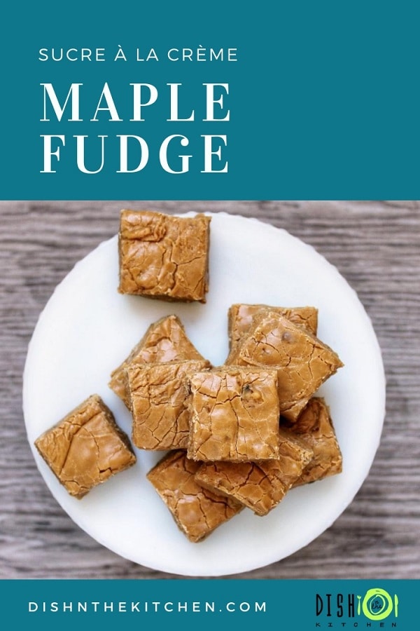 A white plate of light brown maple fudge on a grey wooden table.