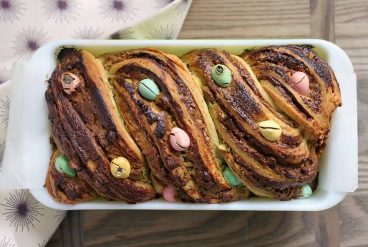 Pistachio Cream and Mini Egg Babka - Baked layered babka dotted with mini eggs in a loaf pan.