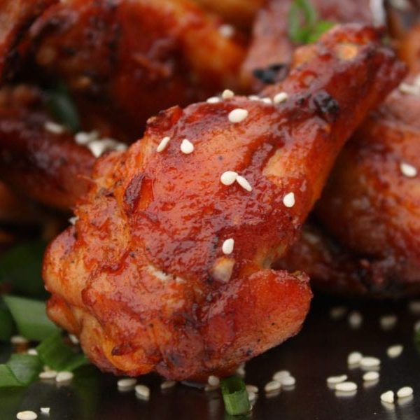 red hicken Wings with white sesame seeds and green onions. 