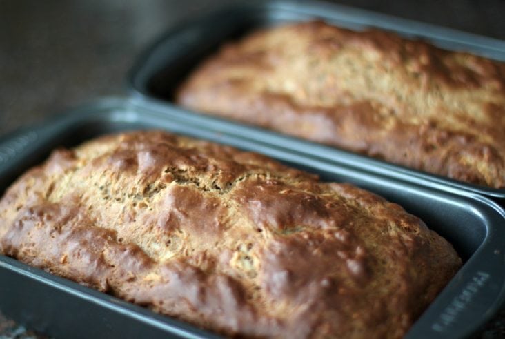 Two loaf pans filled with freshly baked pear bread.