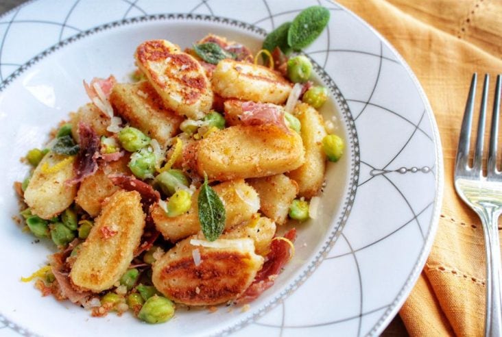 Pillowy soft Ricotta Gnocchi, or Gnudi served with sweet peas, crispy proscuitto, crunchy breadcrumbs, and accented with fresh sage. #Gnocchi #gnudi #pasta #dinner #comfortfood