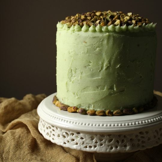 This Chai Layer Cake with Pistachio Buttercream is sweet little cake with a whole lot of attitude. Recipe makes three 6 inch layer cakes and enough pistachio buttercream to sandwich between layers, cover the cake, and all some decorative touches. #birthdaycake #chaicake #layercake #pistachiobutercream