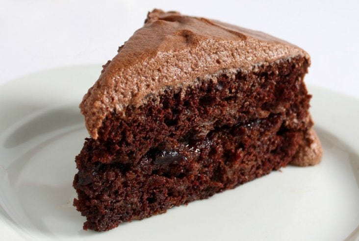 Sauerkraut Chocolate Cake - A generous slice of frosted chocolate cake on a white plate.
