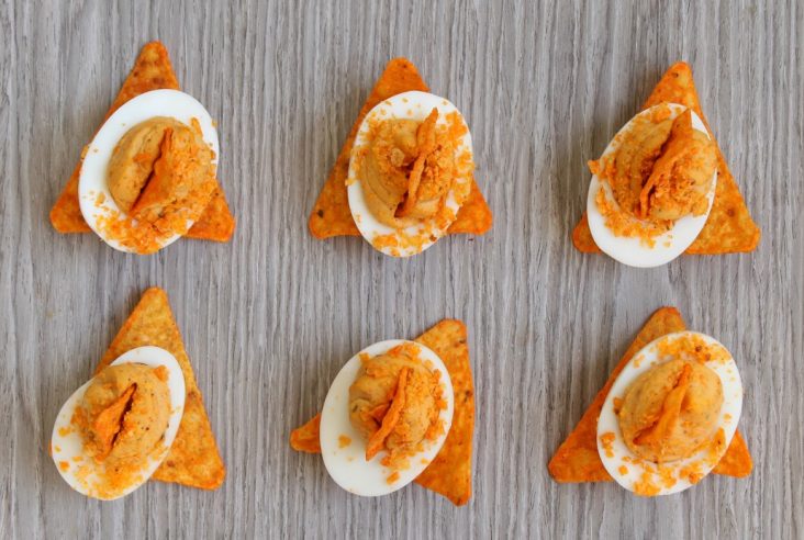 These Zesty Nacho Deviled Eggs have all the flavour of classic deviled eggs plus a kick of taco spice and the crunch of Dorito crumbs. Perfect for game day, potluck, or any family gathering. #deviledeggs #doritocrumb #nachoeggs #nachodeviledeggs