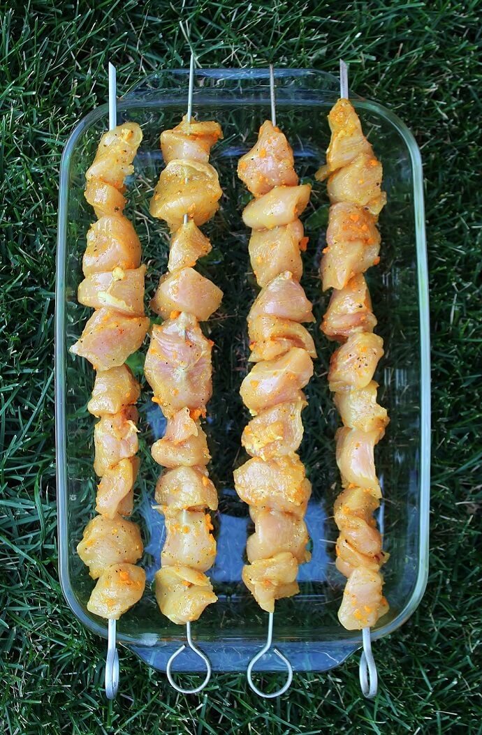 Raw marinated chicken kabobs.