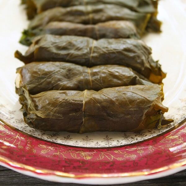 Beet Leaf Rolls (Holubtsi) - Dish 'n' the Kitchen Cooked beet rolls on a fine china platter.