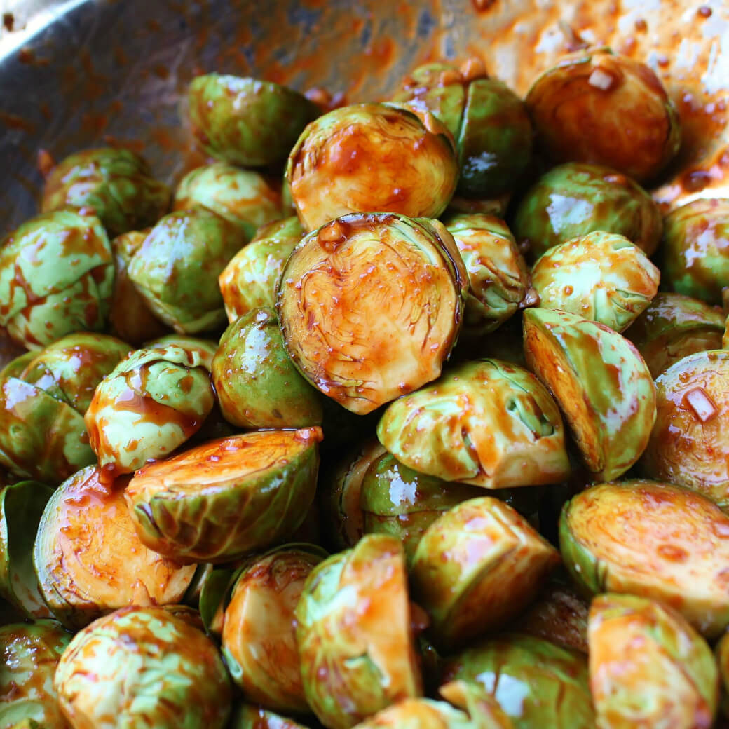 Maple Gochujang Roasted Brussels Sprouts - Close up of gochujang and garlic coated Brussels Sprouts.