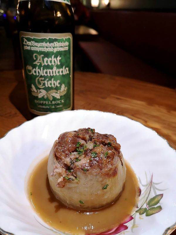 Rain Dog Bar - A braised onion filled with confit pork with smoked Scotch ale demiglace.