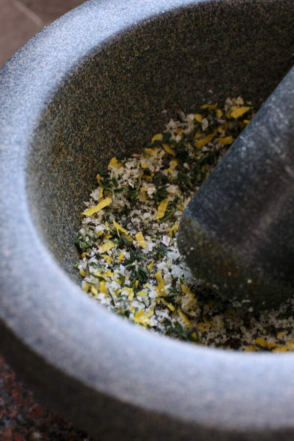 Dry Brine Chicken - A green basalt mortar containing citrus herb dry rub and a pestle.