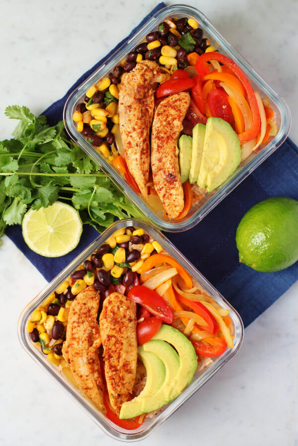 Simply Delicious Chicken Burrito Bowl - overhead shot of two square glass fridge containers filled with chicken, rice, peppers, avocado, corn and beans.
