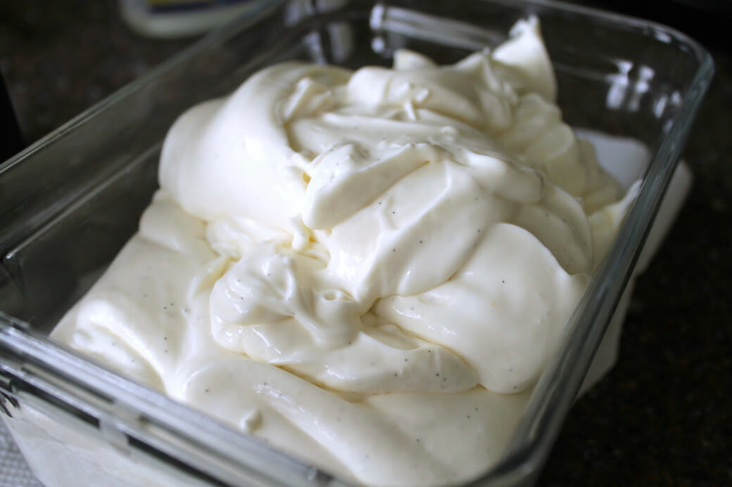 A tub of soft white ice cream ready to be churned.