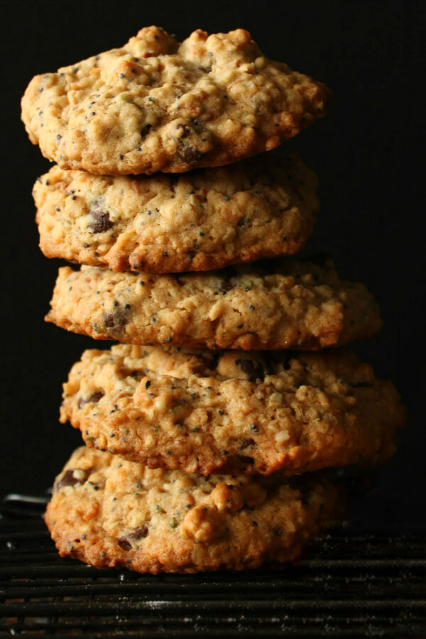 A stack of chocolate chip cookies on a black background.