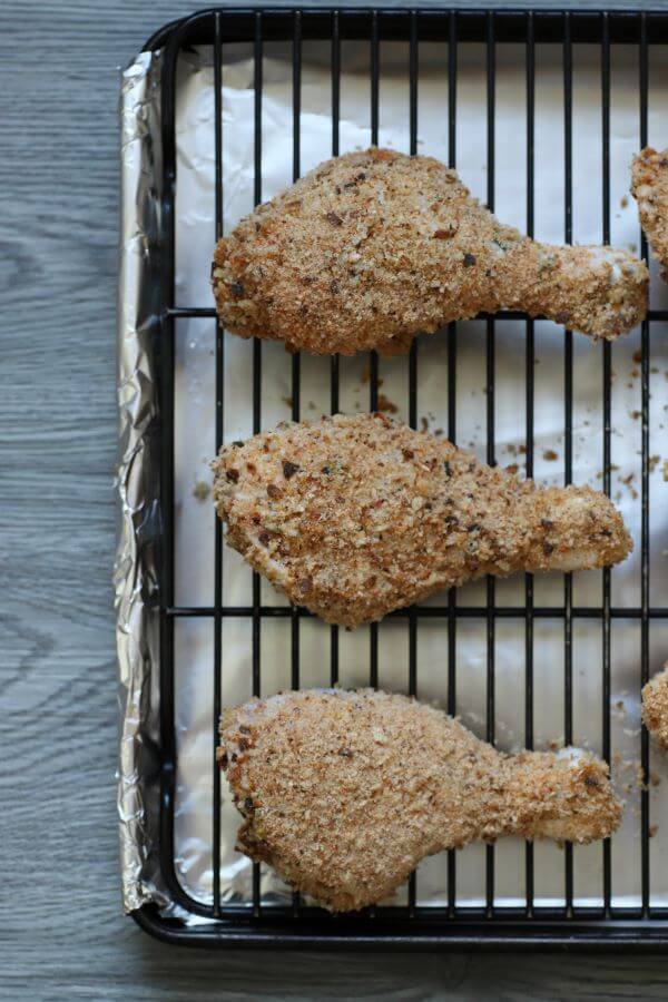 Three pieces of breadcrumb coated chicken on a wire rack.