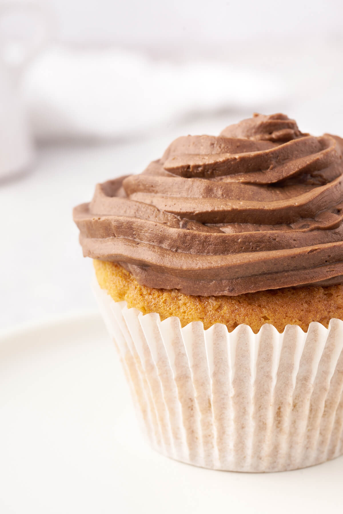 A vanilla cupcake frosted with swirled Nutella frosting.