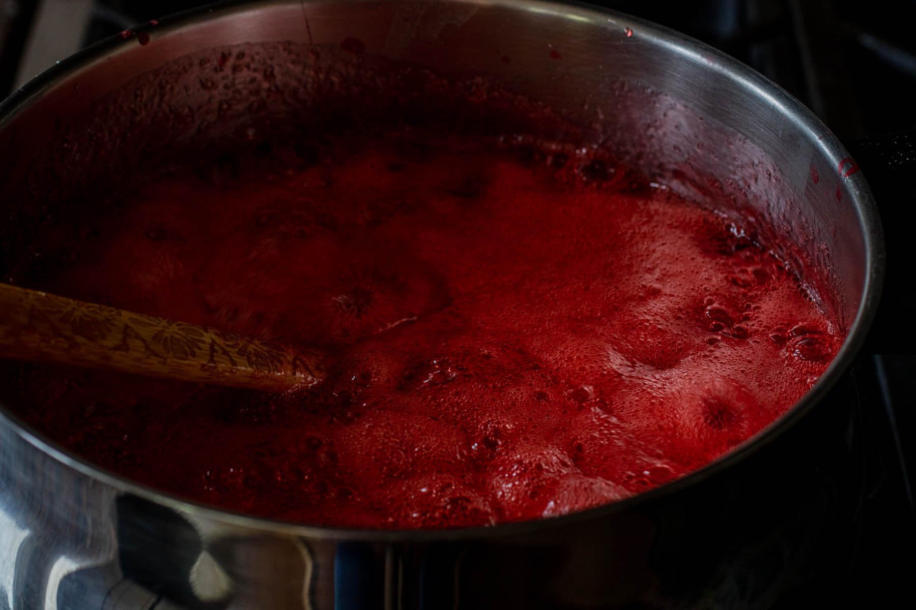 Strawberry Rhubarb Jam at a rolling boil in a large saucepan.