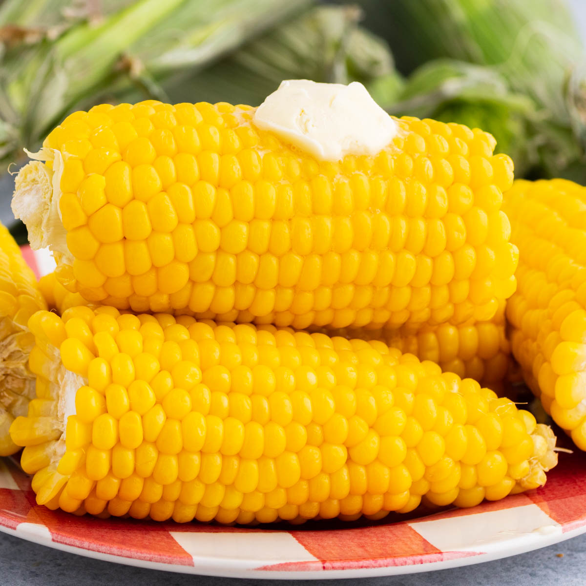 A golden yellow stack of cooked Instant Pot Corn on the Cob with butter.