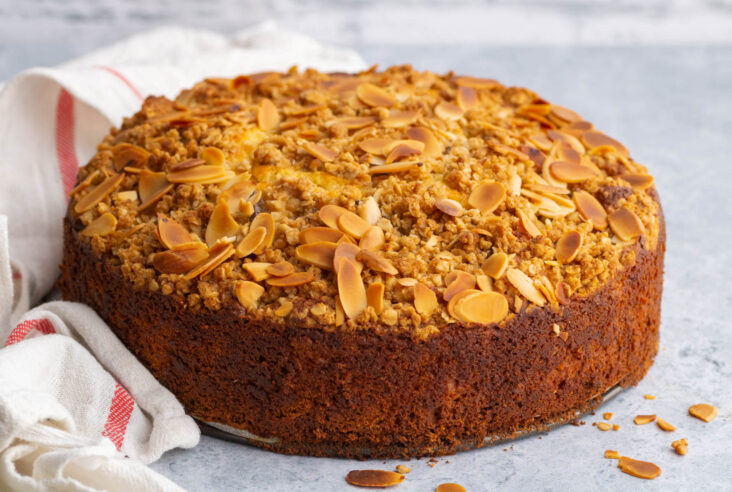 A whole golden baked almond crumble topped Pear Ricotta Cake.