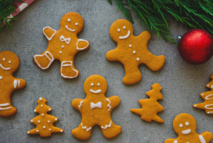 Golden baked easy gingerbread cookies decorated with simple white piped icing embellishments.