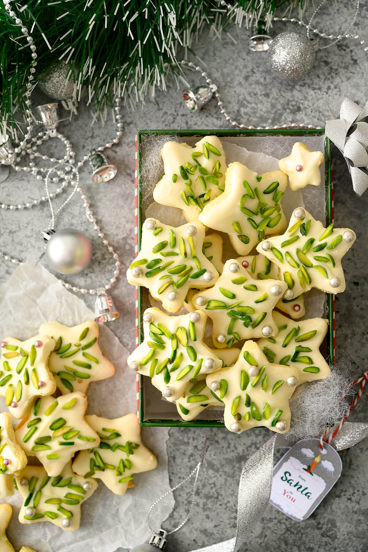 A Christmas cookie box filled with star shaped cookies.