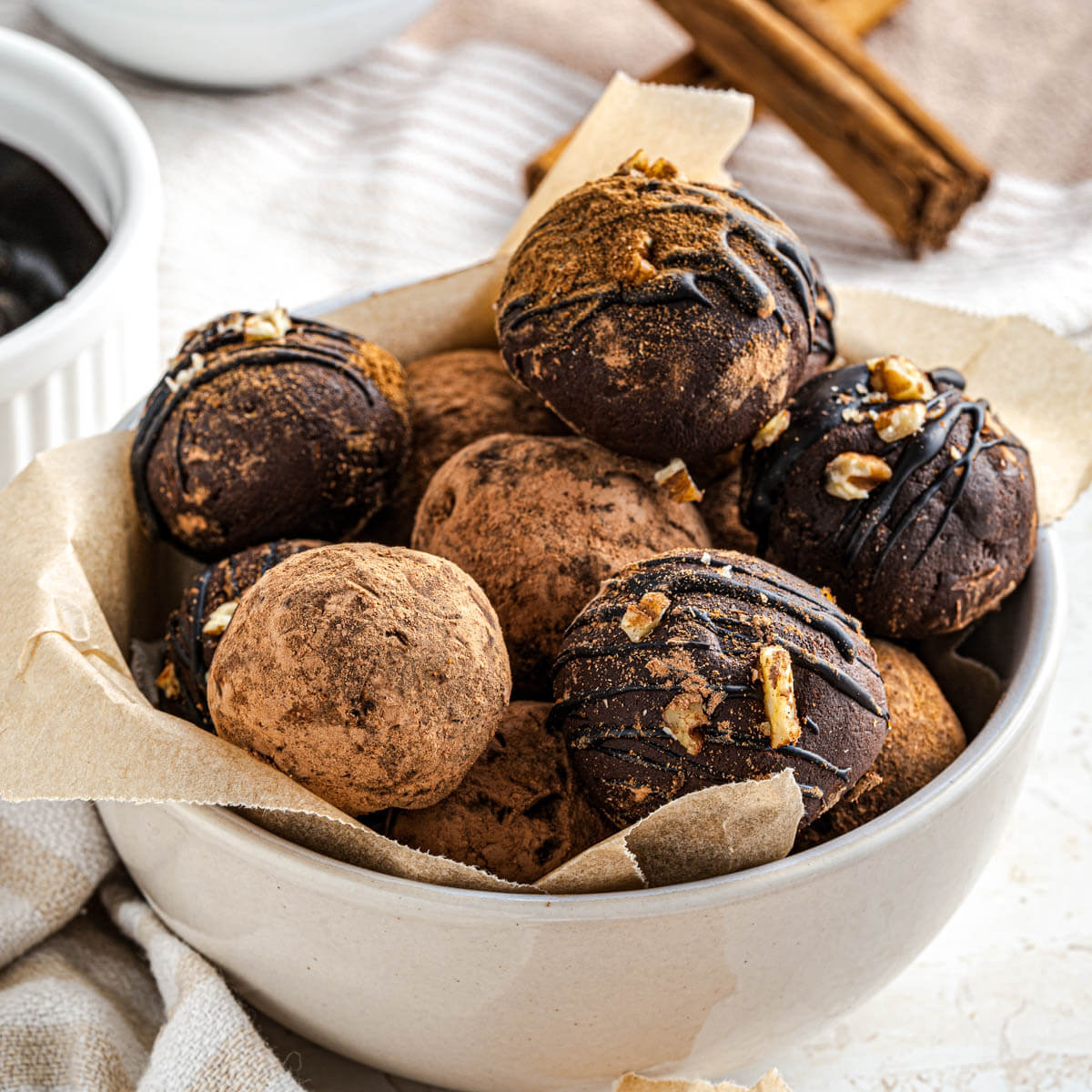 A bowl full of simply decorated dark chocolate avocado truffles.