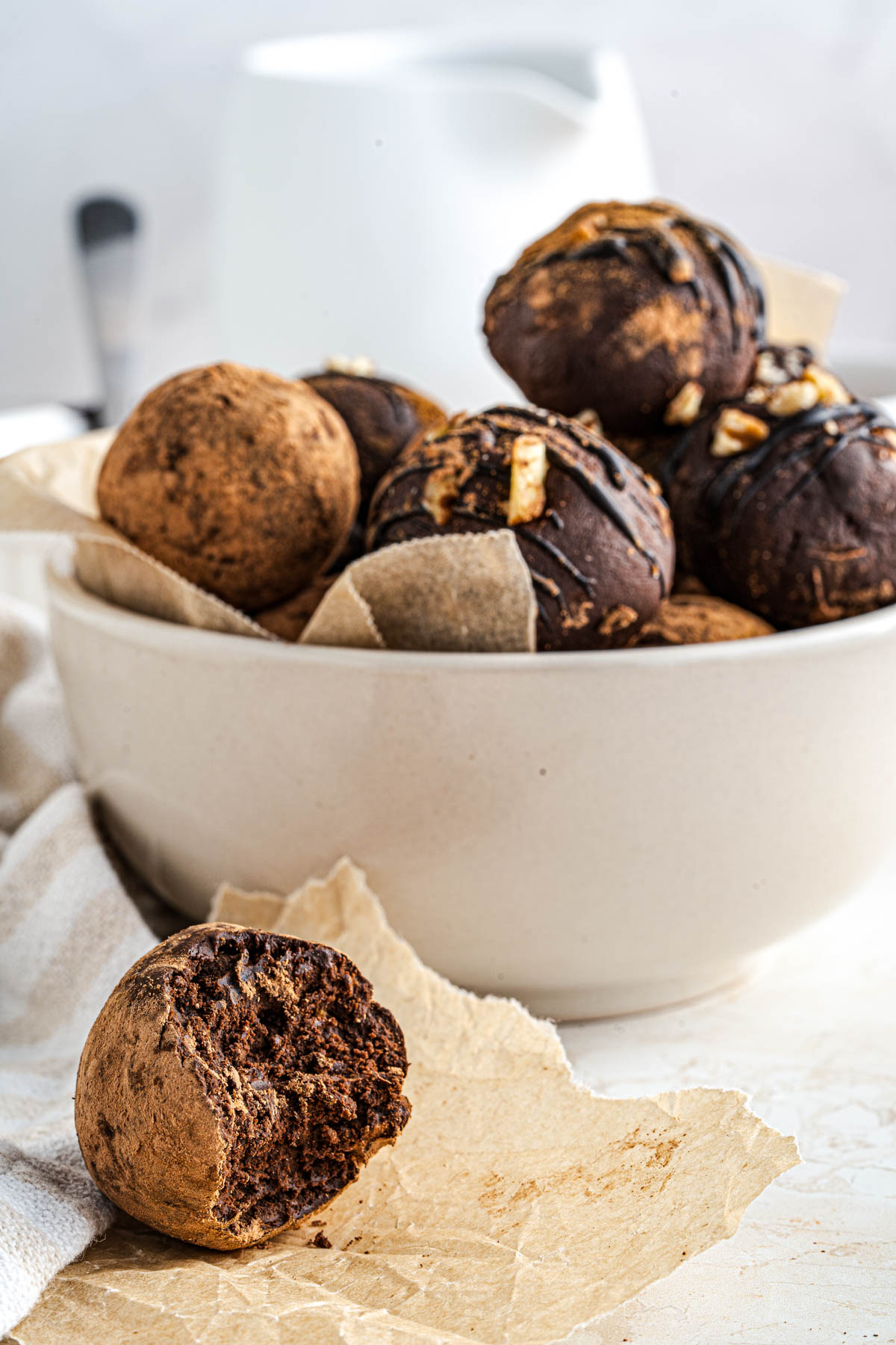 A bowl full of simply decorated dark chocolate avocado truffles.