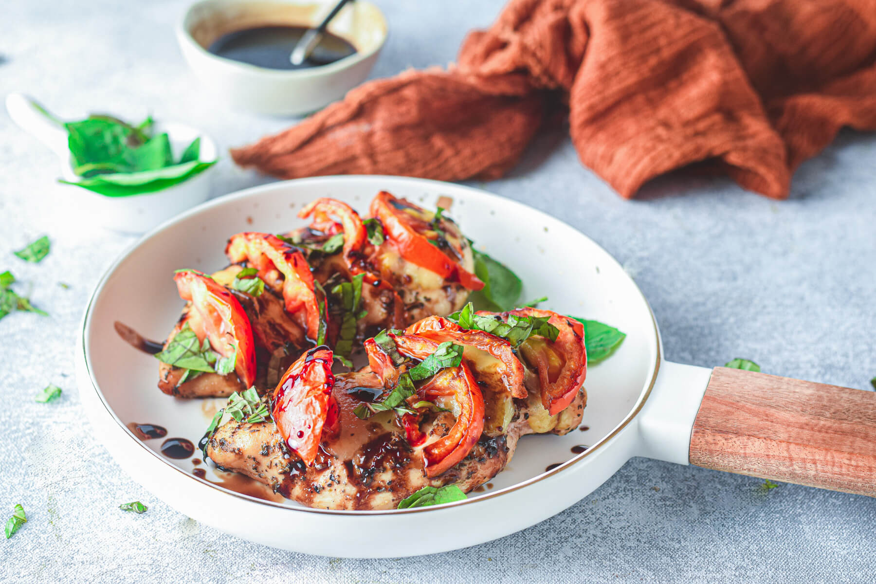 Air fryer caprese chicken with melted mozzarella fresh tomato and balsamic glaze