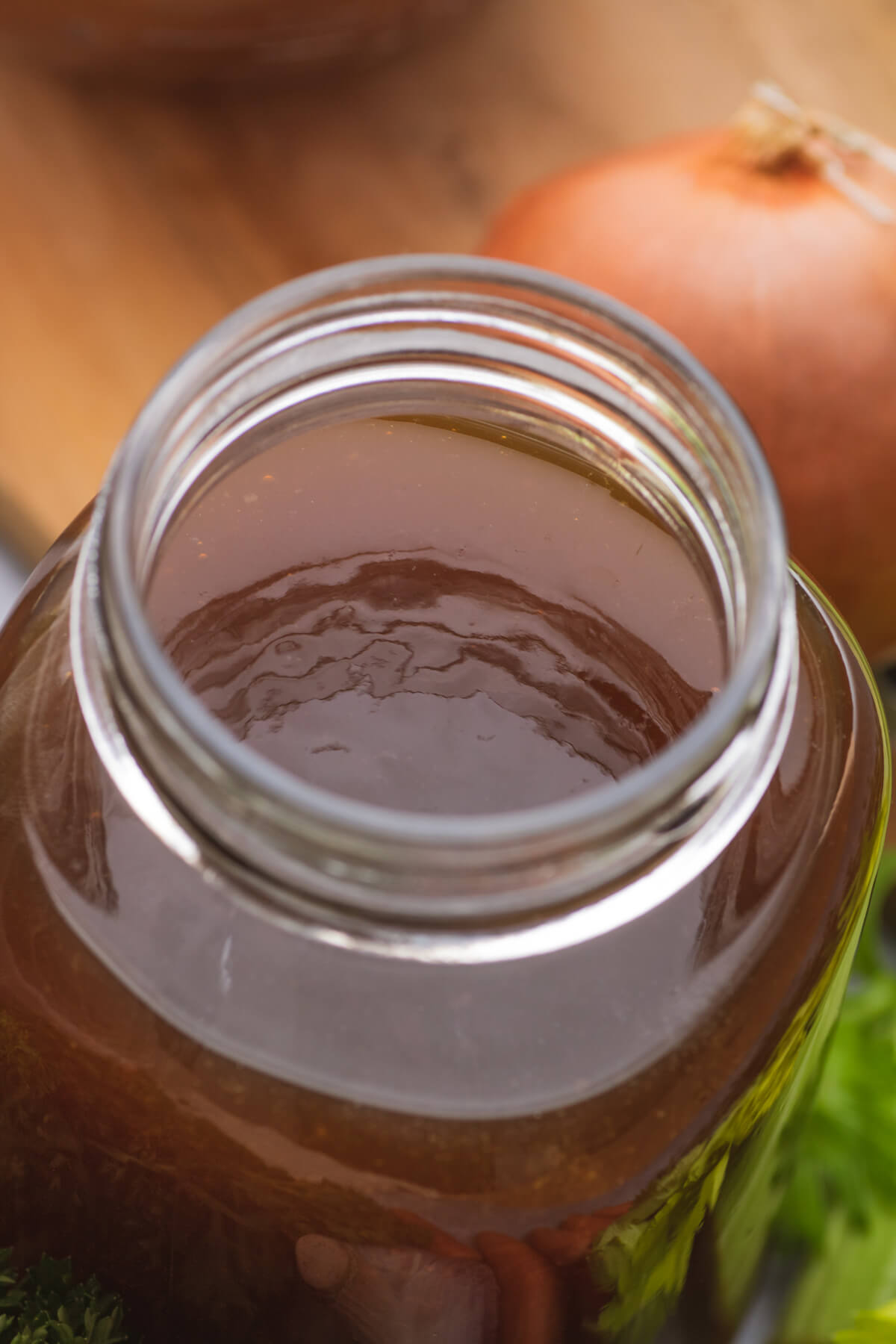A quart jar filled with jelly-like cold beef stock.
