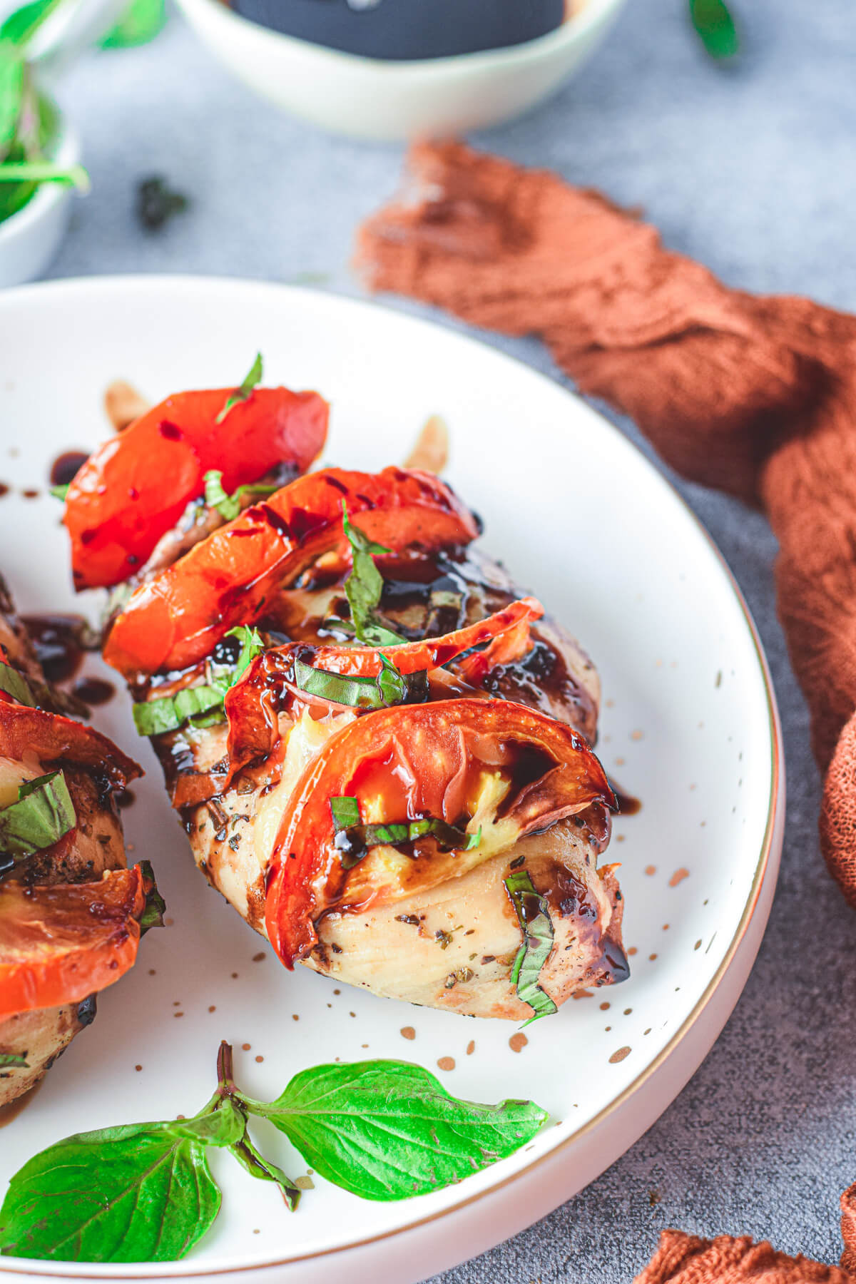 One chicken caprese stuffed with mozzarella and tomatoes then garnished with fresh basil and balsamic drizzle.