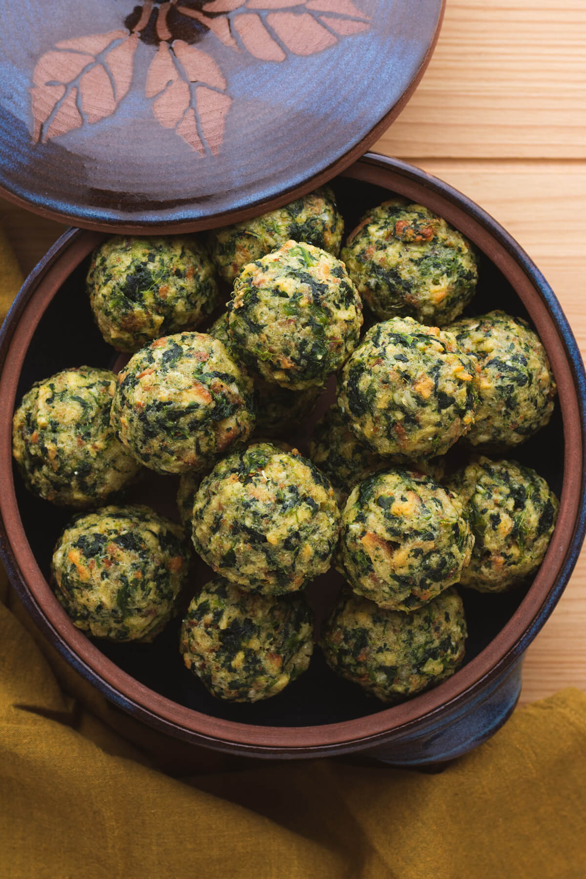 Spinach Stuffing Balls in a ceramic casserole dish.