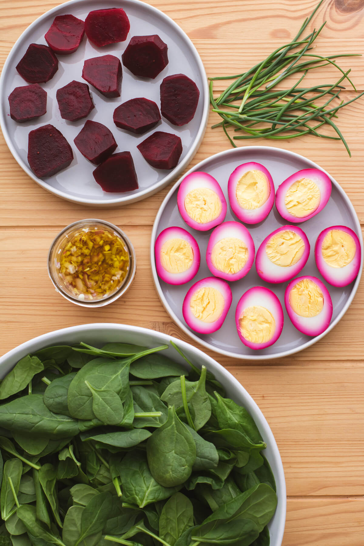Ingredients needed to make beet spinach salad with beet pickled eggs and beets.