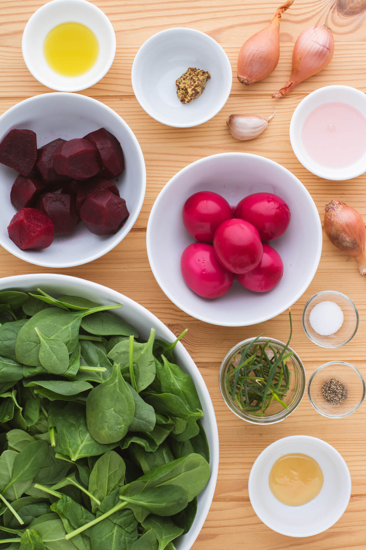 Ingredients needed to make beet spinach salad with beet pickled eggs and beets.