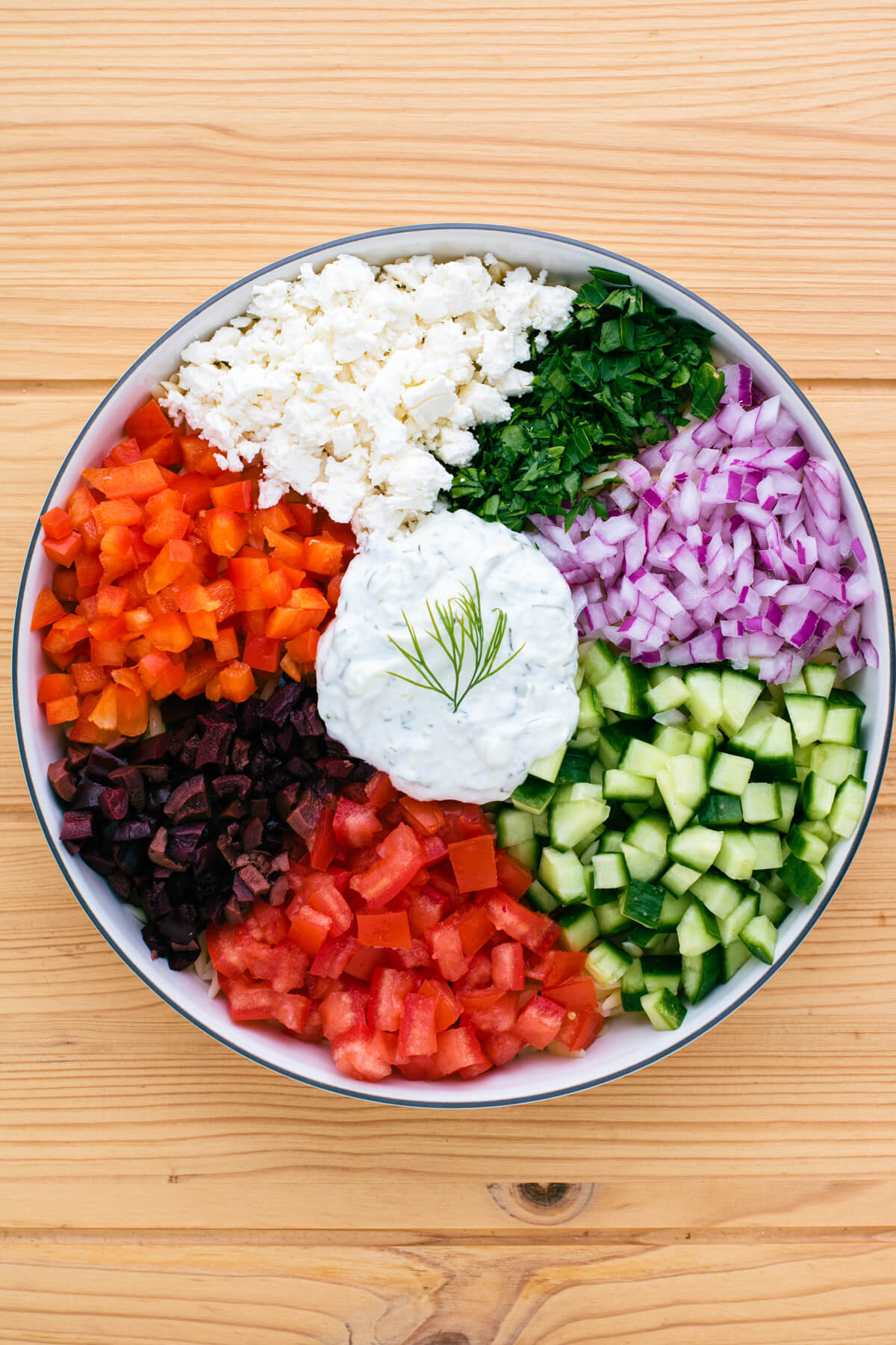 A bowl of salad ingredients before they are mixed together.