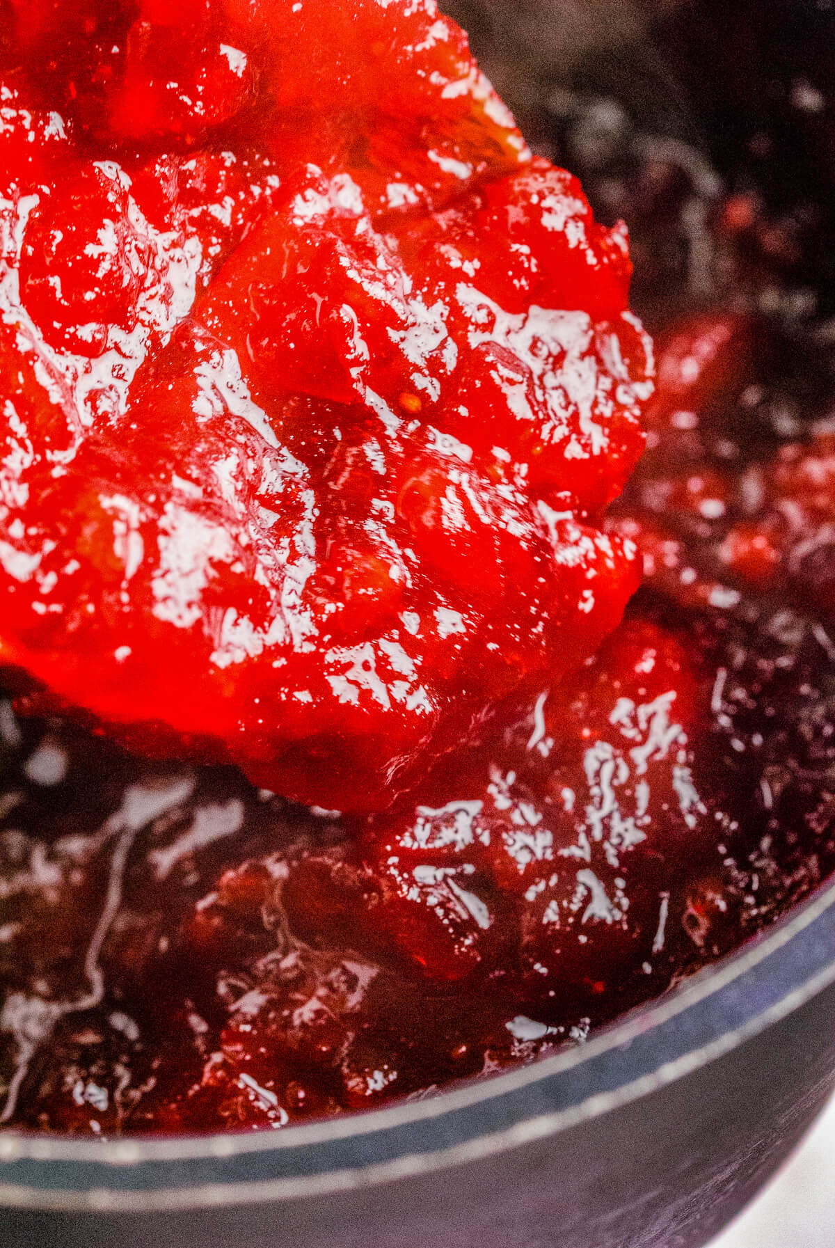 Close up of cranberry sauce on a spoon.