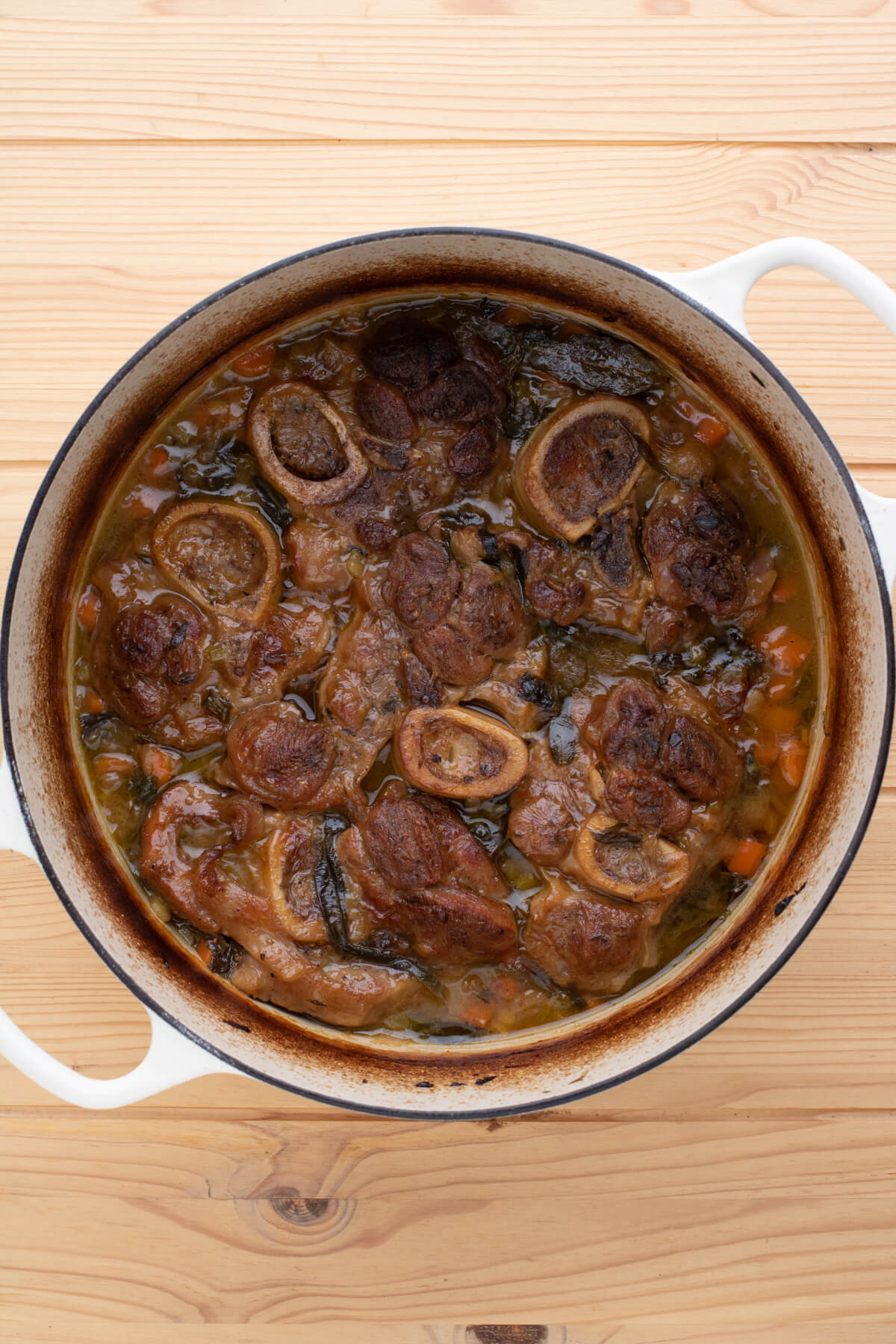 A Dutch oven filled with veal Osso Bucco.
