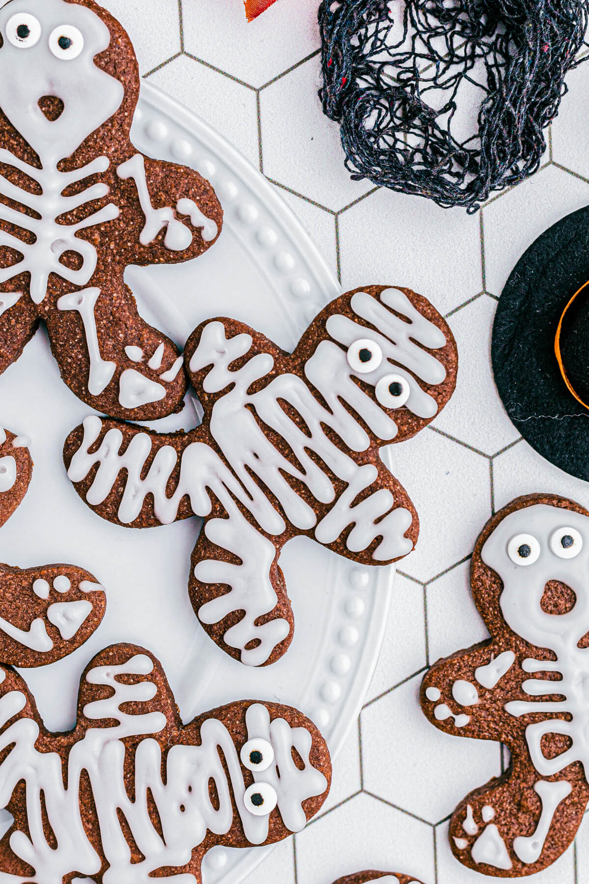 A platter of Chocolate Halloween Sugar Cookies decorated as mummies and skeletons.