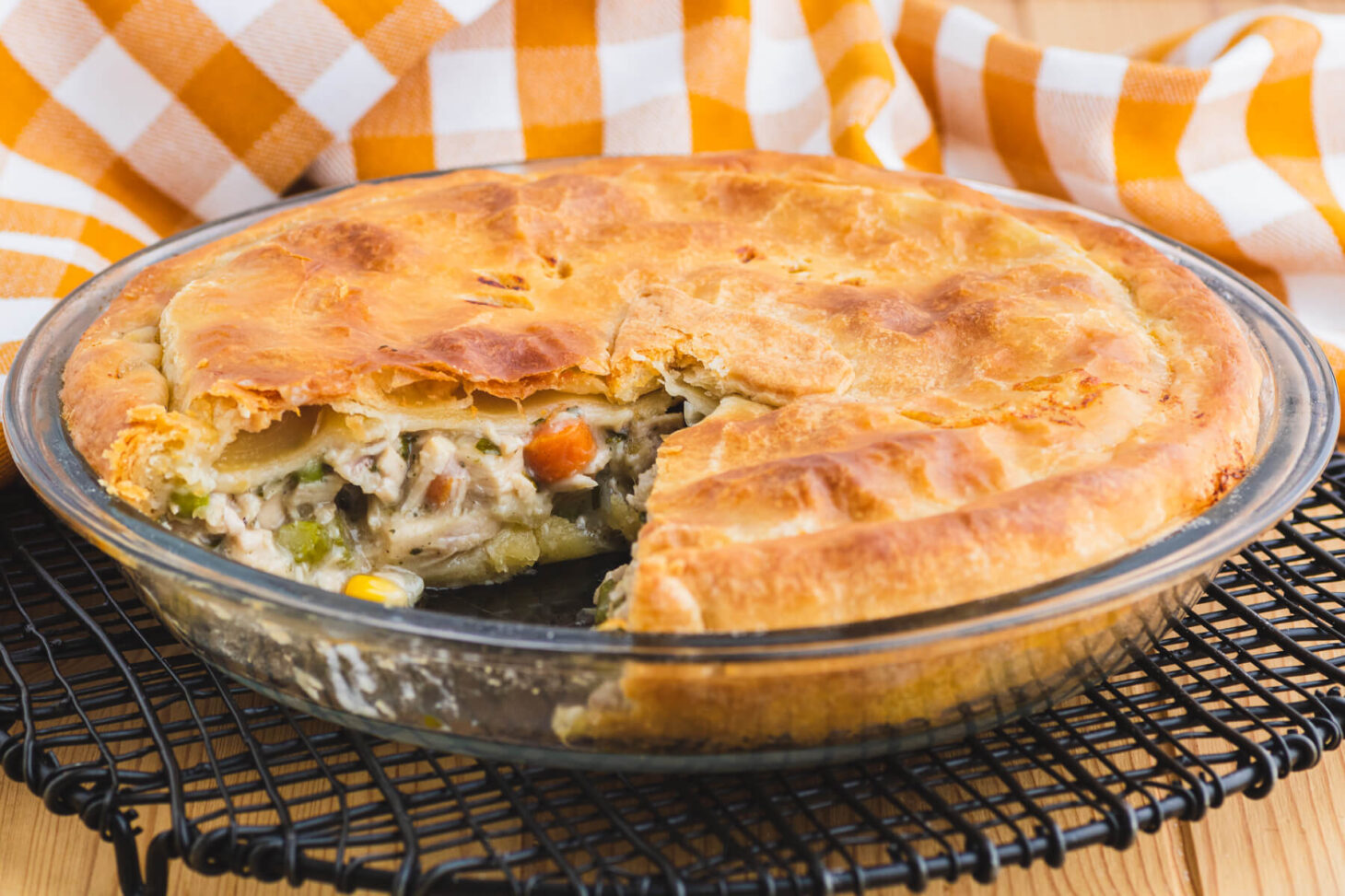 A golden baked turkey pot pie with a slice missing.