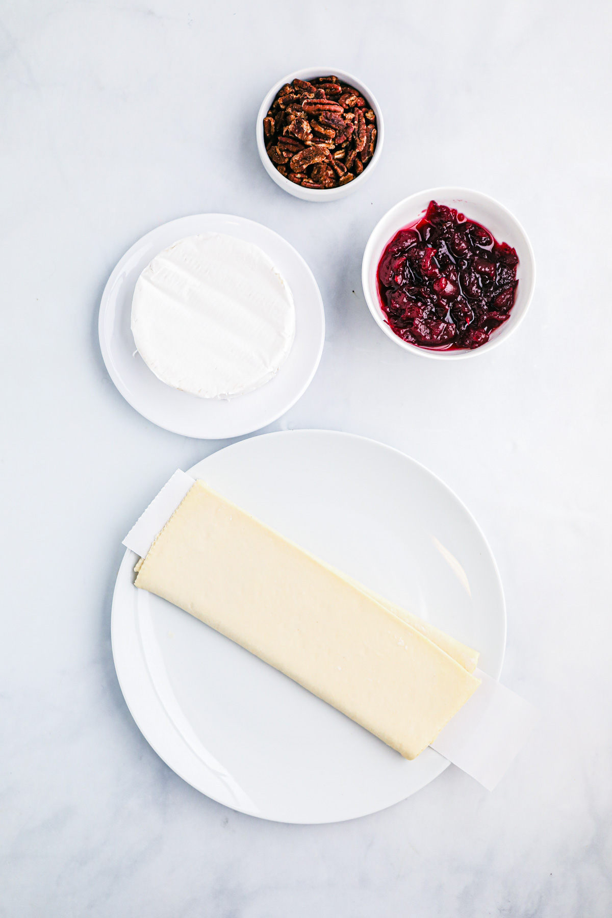 Ingredients required to make Brie en Croute with Cranberries and pecans.