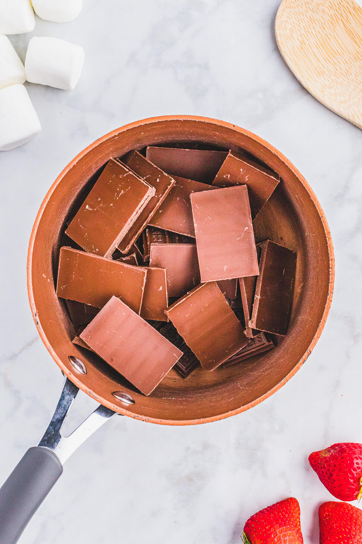 Chocolate squares in a copper pot. 