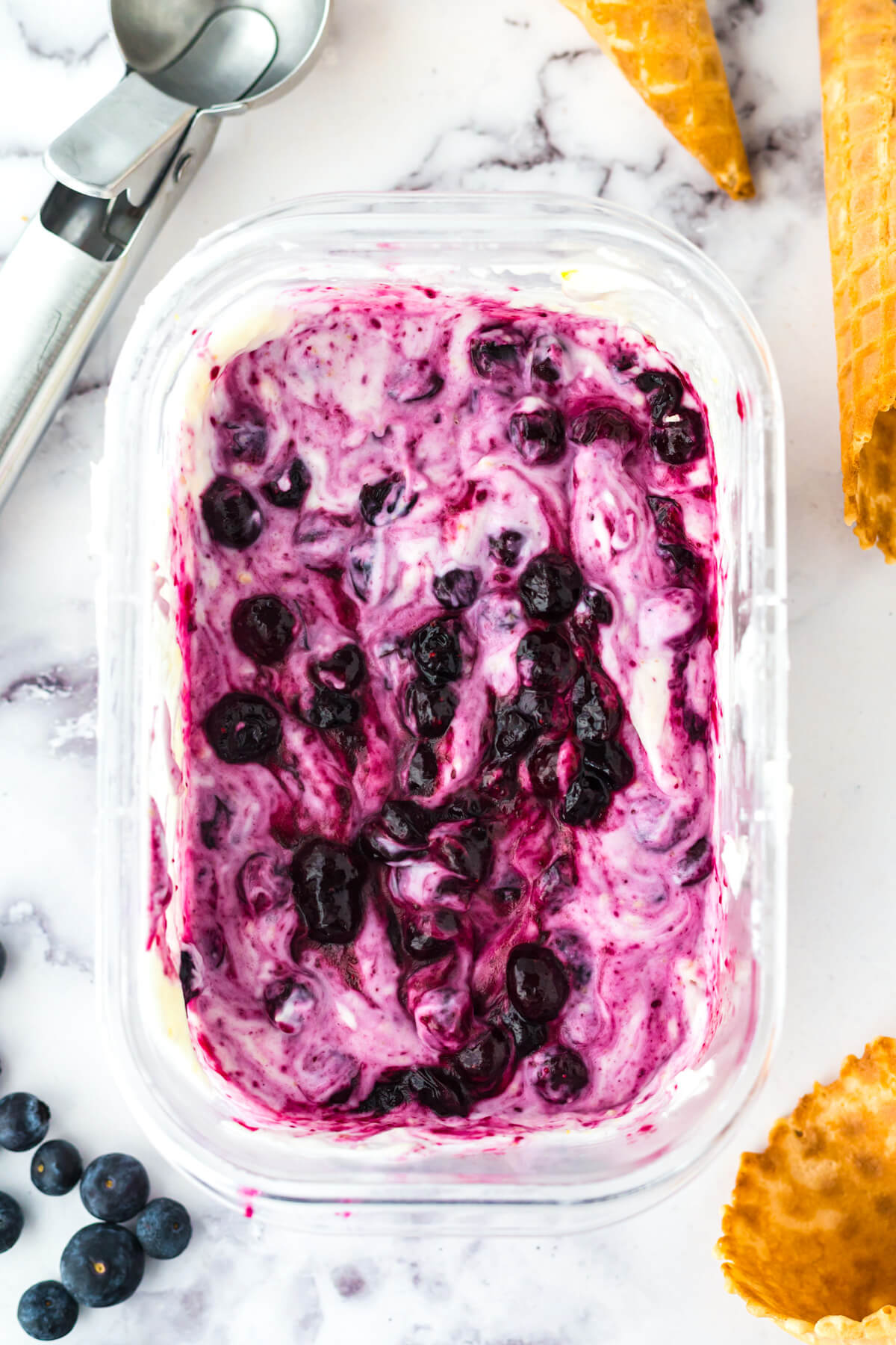 An ice cream tub filled with Blueberry Cheesecake Ice Cream.