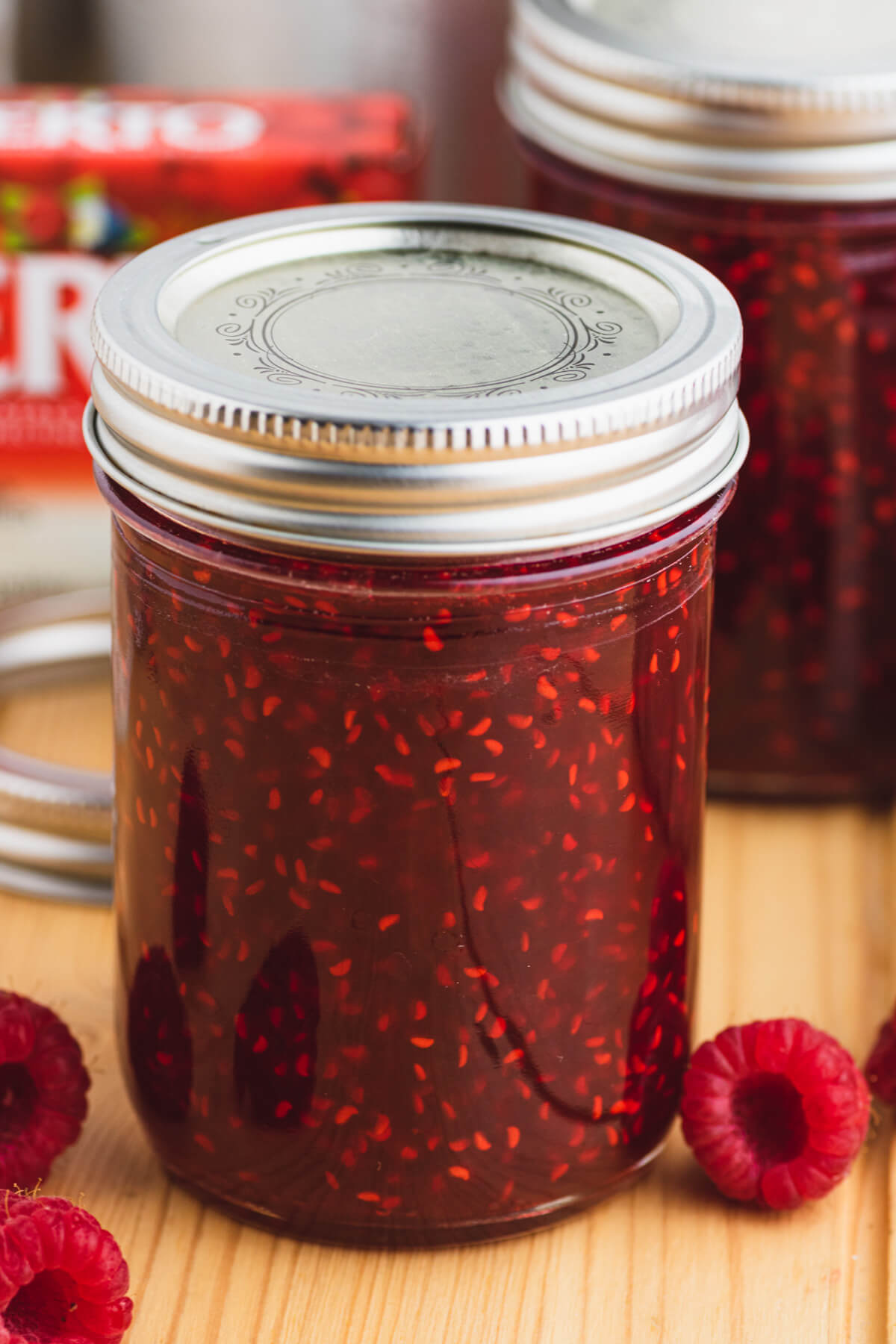 A single sealed jar of raspberry jam.
