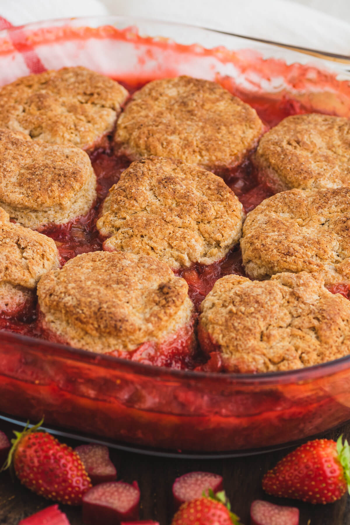 Golden baked biscuit cobbles on top of strawberry rhubarb cobbler.