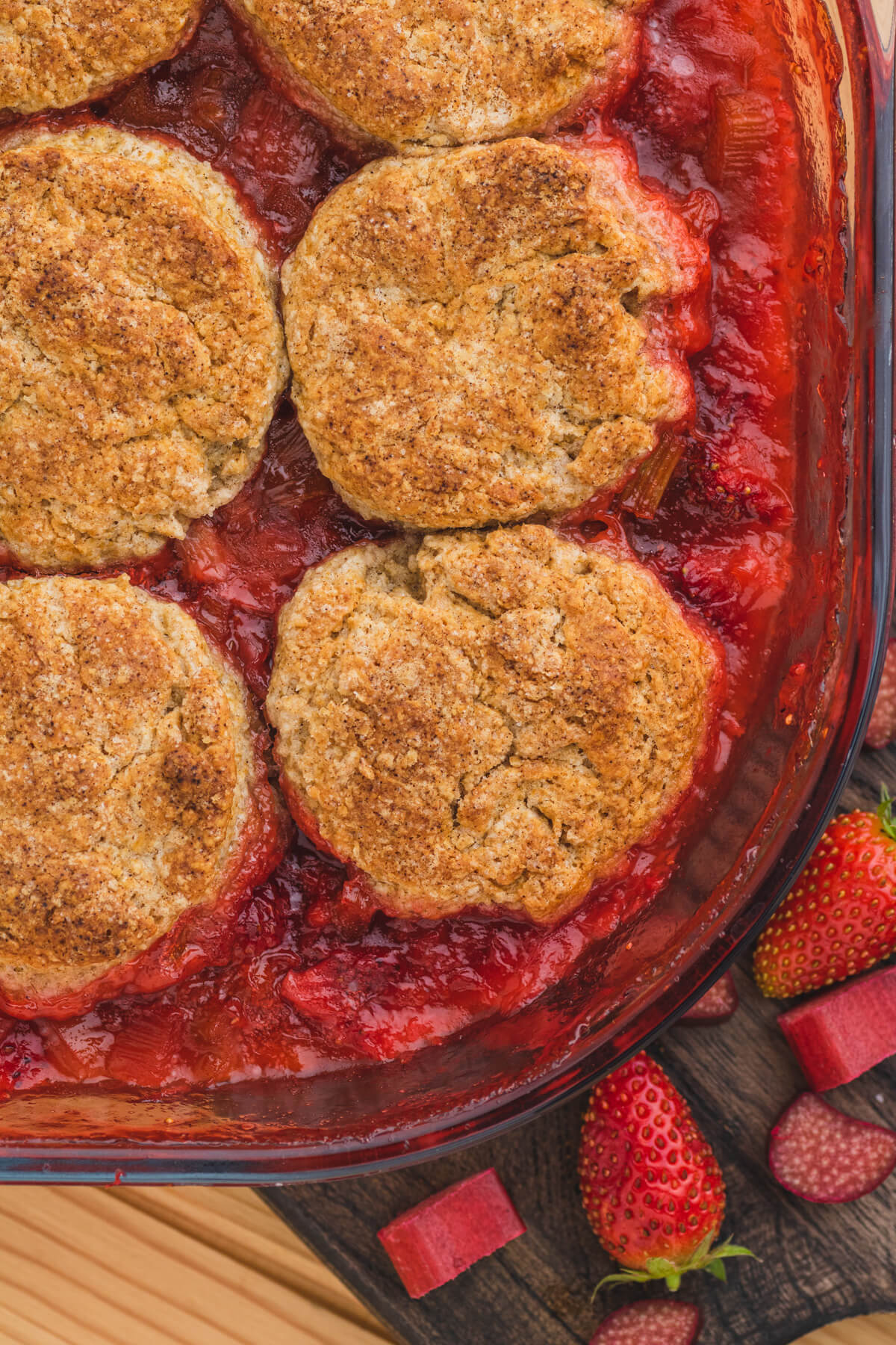 Golden baked biscuit cobbles on top of strawberry rhubarb cobbler.
